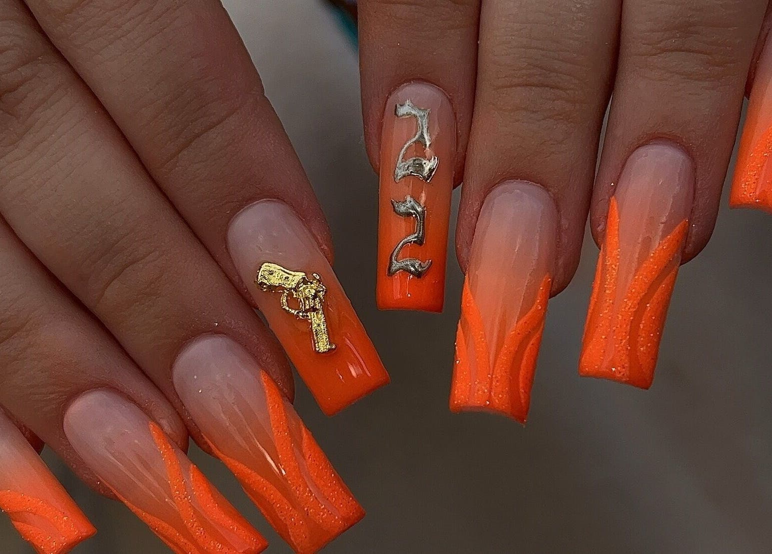Vibrant orange nail art at Dimepiece Beauty, Melbourne, Victoria, AU, with unique gold accents.