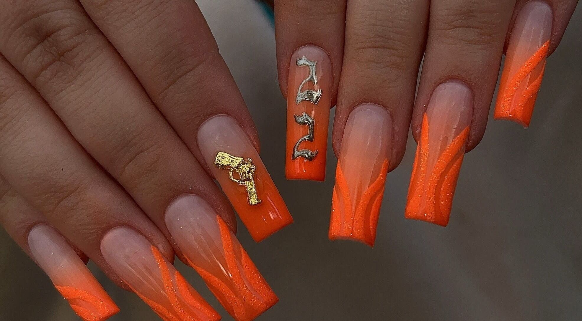 Vibrant orange nail art at Dimepiece Beauty, Melbourne, Victoria, AU, with unique gold accents.