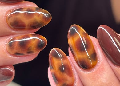 Stylish tortoise shell nails by Nails by Phoebs in Rushden, England, GB, showcasing intricate artistry.