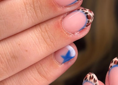 Leopard print nails with blue accents by Nails by Phoebs in Rushden, England, GB.