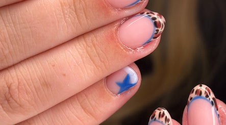 Leopard print nails with blue accents by Nails by Phoebs in Rushden, England, GB.