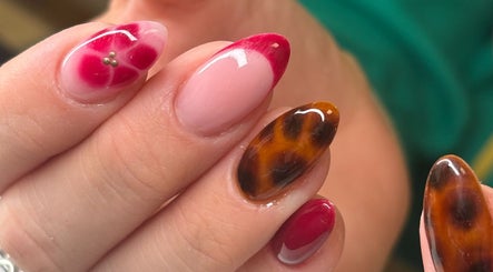 Intricate red and brown nail art at Nails by Phoebs, Rushden, England, GB, showcasing diverse designs.