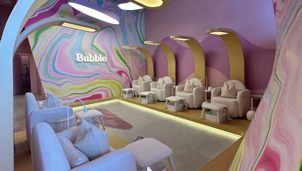 Elegant seating area at Bubble, Riyadh, Riyadh Province, SA, with colorful wall art and cozy chairs.
