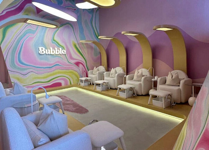 Elegant seating area at Bubble, Riyadh, Riyadh Province, SA, with colorful wall art and cozy chairs.