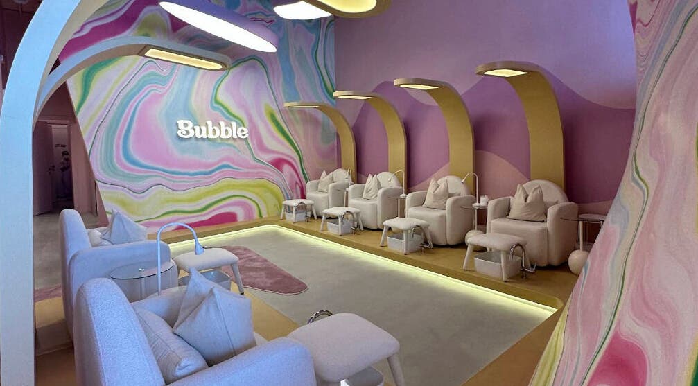 Elegant seating area at Bubble, Riyadh, Riyadh Province, SA, with colorful wall art and cozy chairs.