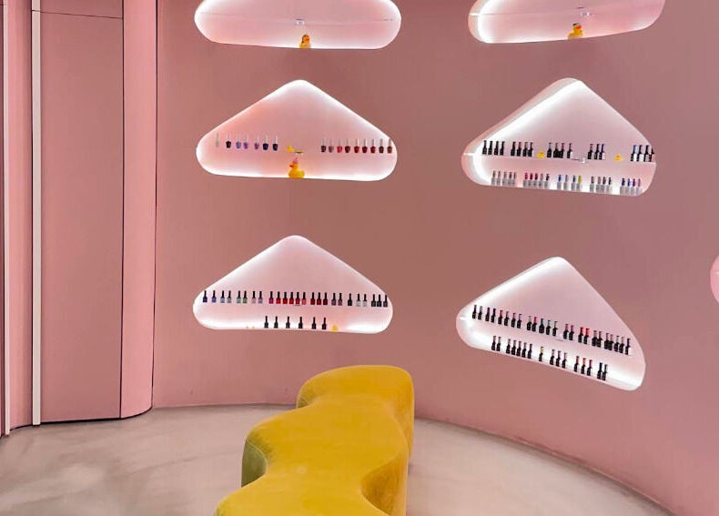 Chic interior with pink walls and nail polish display at Bubble, Riyadh, Riyadh Province, SA.