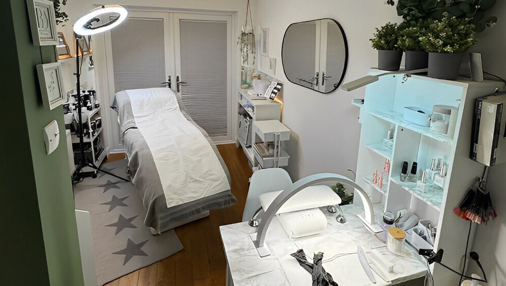 Cozy treatment room in Beauty Suite by Annabel, Eastleigh, England, GB, featuring a massage bed and nail station.