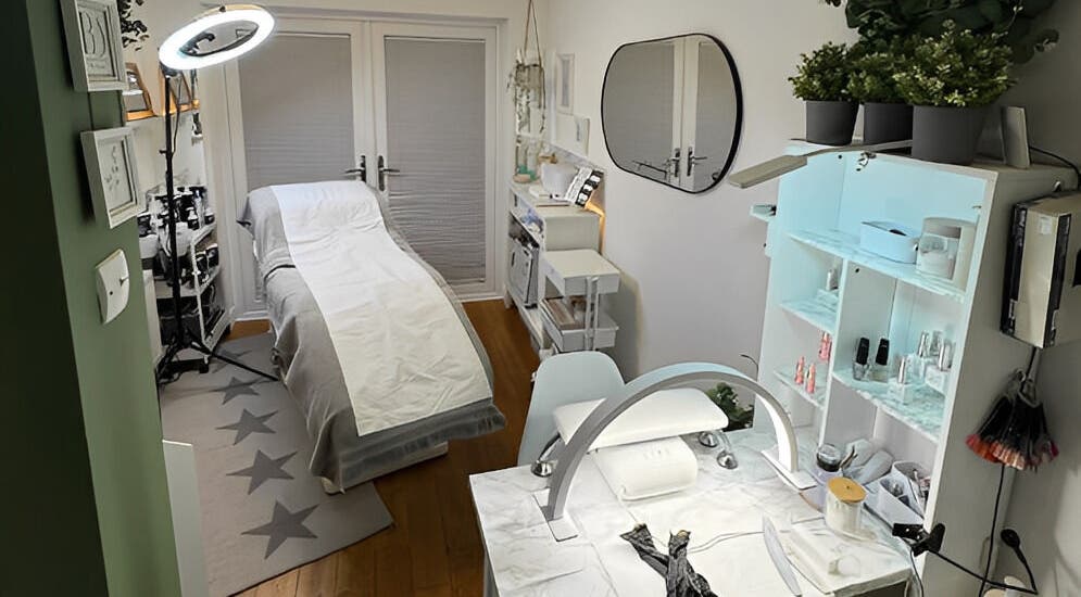 Cozy treatment room in Beauty Suite by Annabel, Eastleigh, England, GB, featuring a massage bed and nail station.