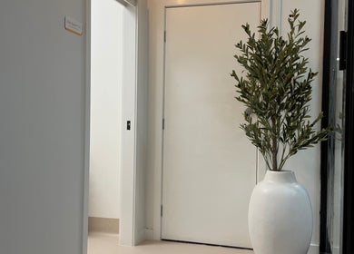Elegant white entrance with potted plant at Lash'd By Maddy, Morisset, New South Wales, AU.