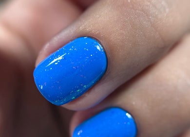 Gleaming blue nail polish by Rebel Beauty by Danka in Birmingham, England, GB.