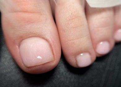 Close-up of a pedicure at Rebel Beauty by Danka in Birmingham, England, GB showcasing glossy polished toenails.