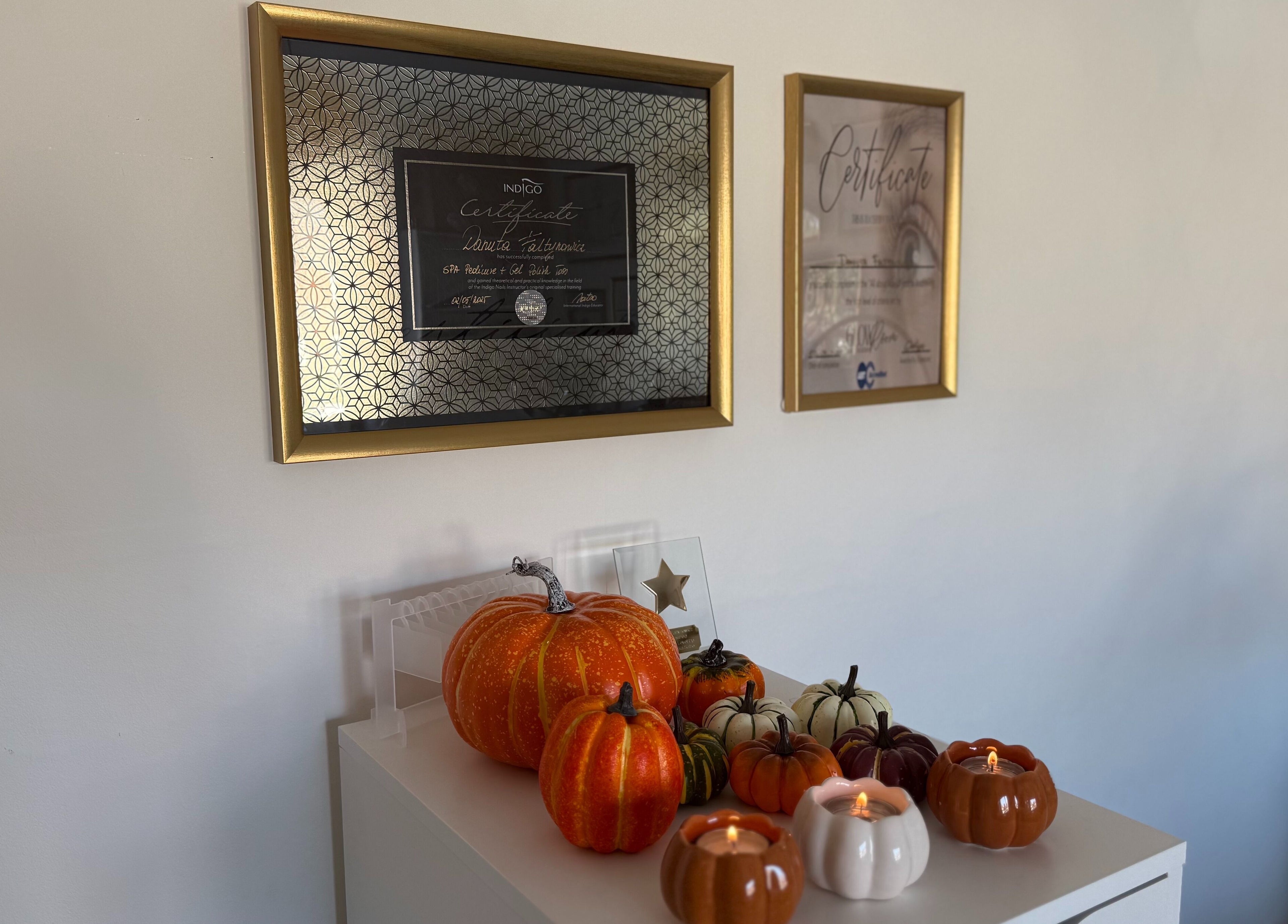 Rebel Beauty by Danka in Birmingham, England, showcases framed certificates and decorative pumpkins.