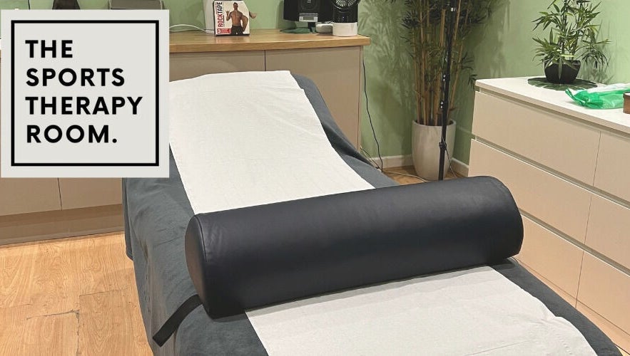 Relaxing therapy room at The Sports Therapy Room, Milnrow, England with massage bed and decor.