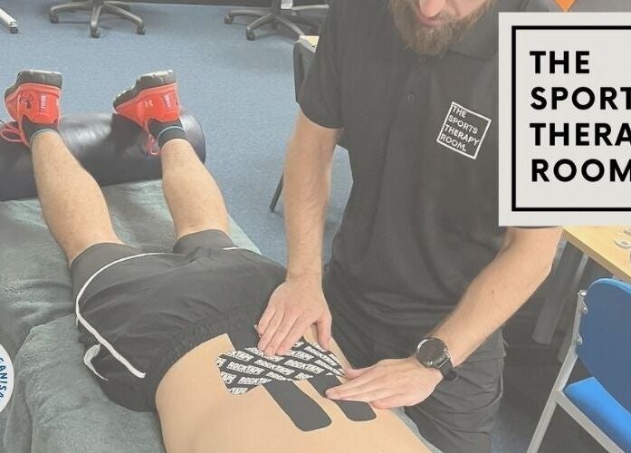 Therapist applying kinesiology tape at The Sports Therapy Room, Milnrow, England, GB.