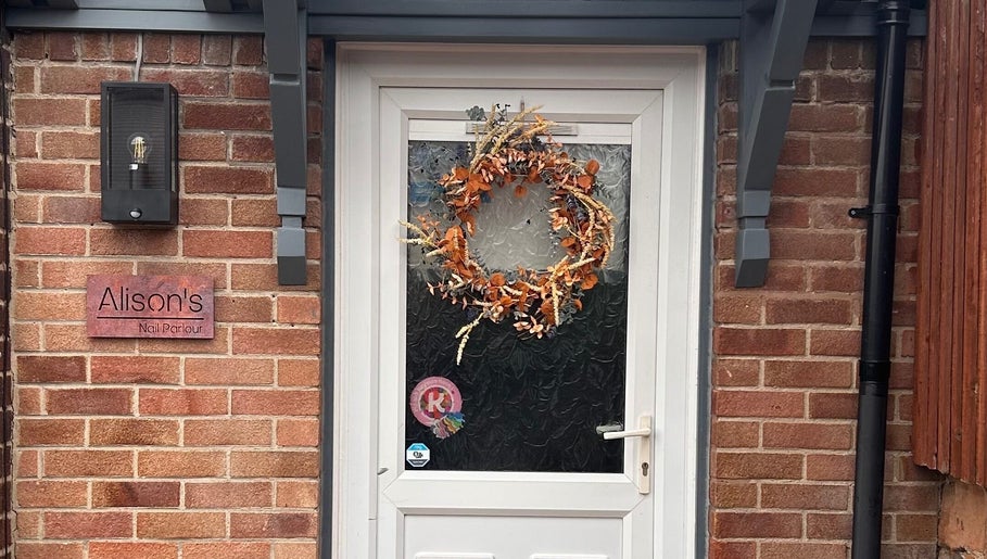 Entrance of Alison’s Nail Parlour in Eastwood, England, GB with decorative wreath on door.