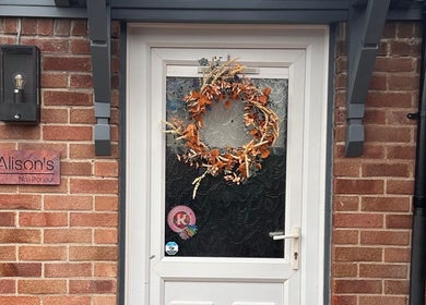 Entrance of Alison’s Nail Parlour in Eastwood, England, GB with decorative wreath on door.