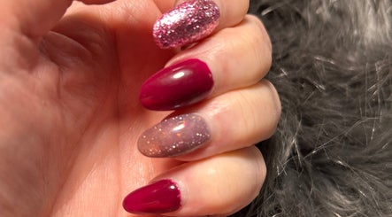 Glittering manicure at Alison’s Nail Parlour, Eastwood, England, GB showcasing vibrant pink and glittery nails.
