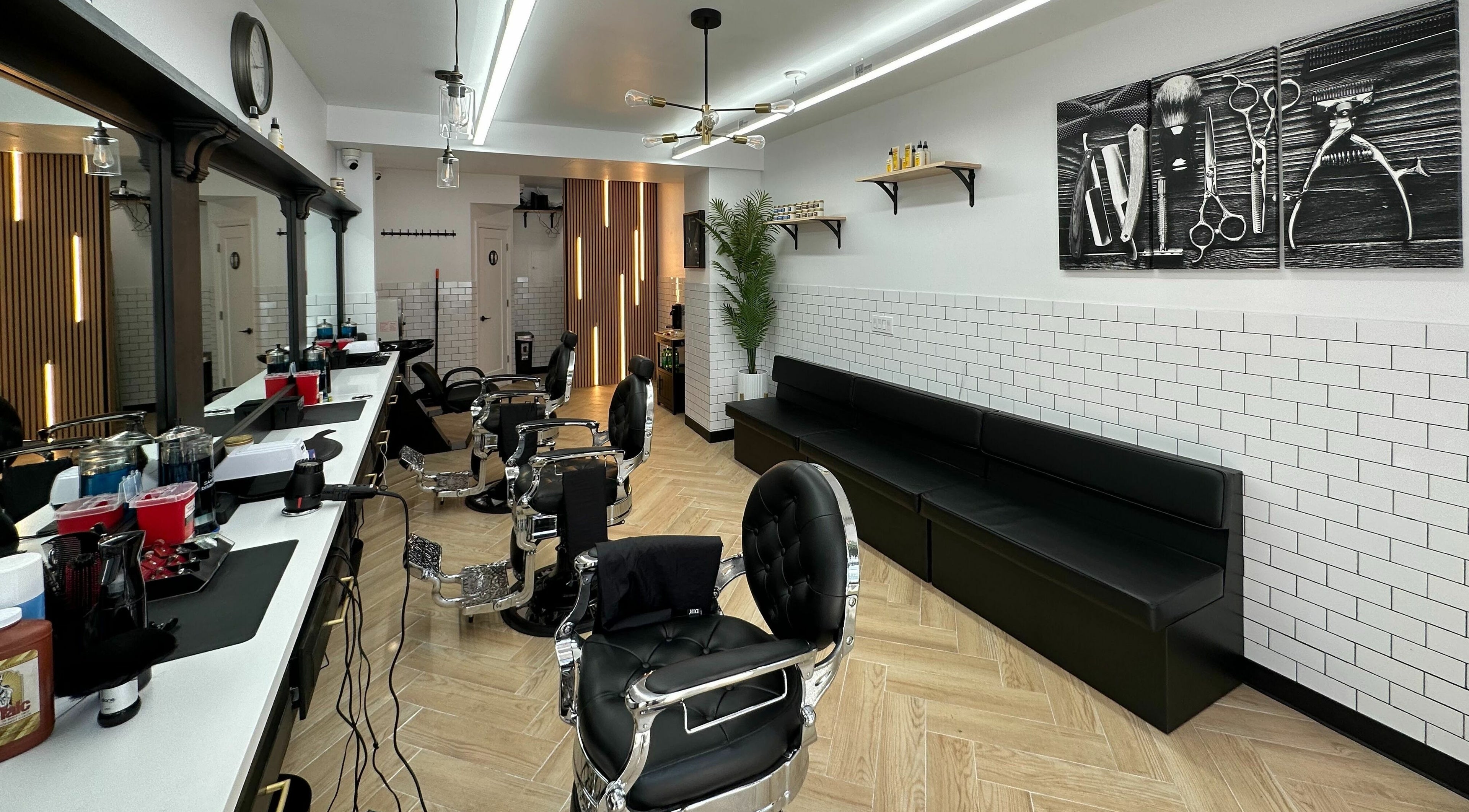 Modern interior of Crown Royal Barbershop in New York, New York, US with sleek chairs and stylish decor.