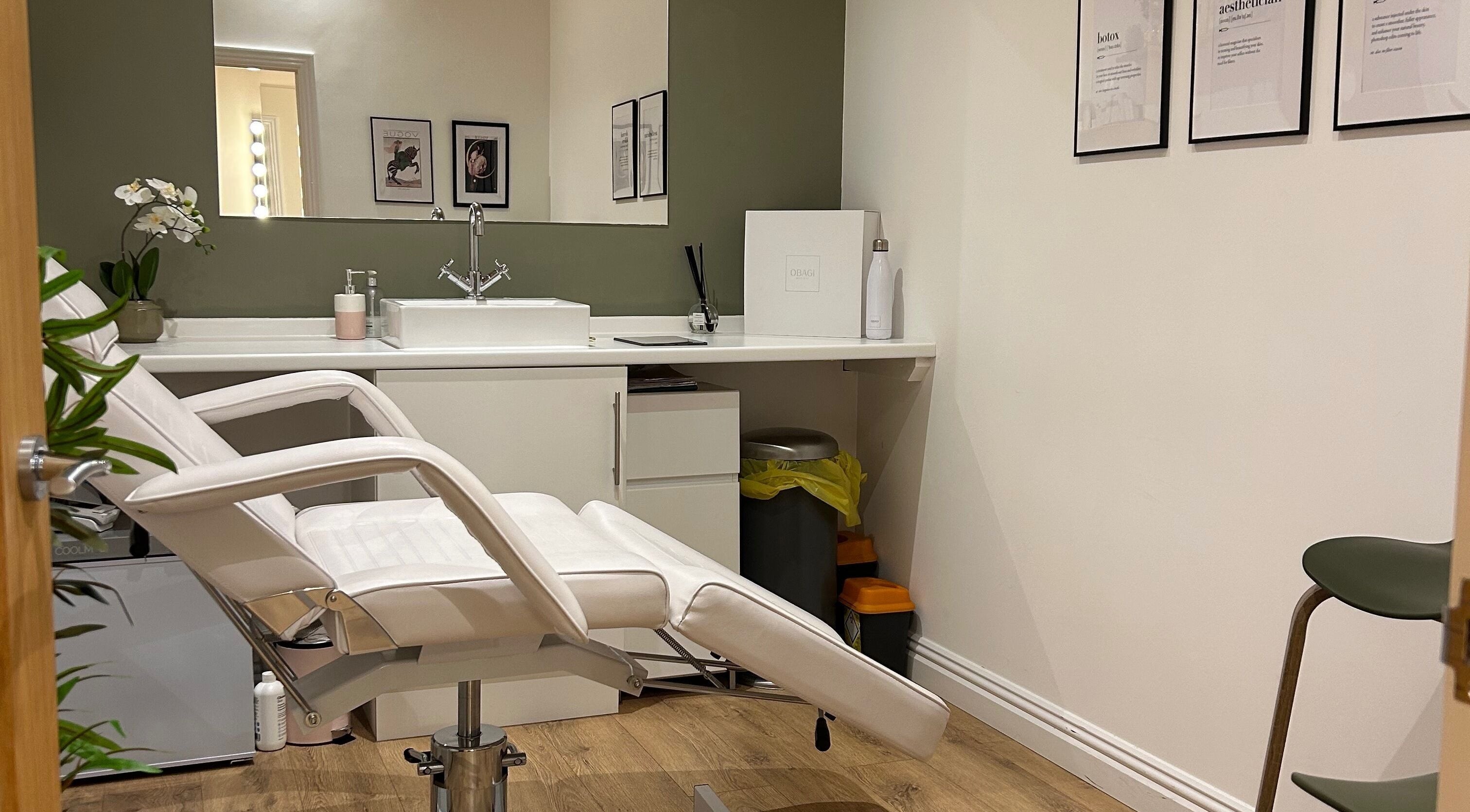 Sophisticated treatment room at The Beauty Barn, Haddenham, England, GB. Modern decor with a white recliner chair.