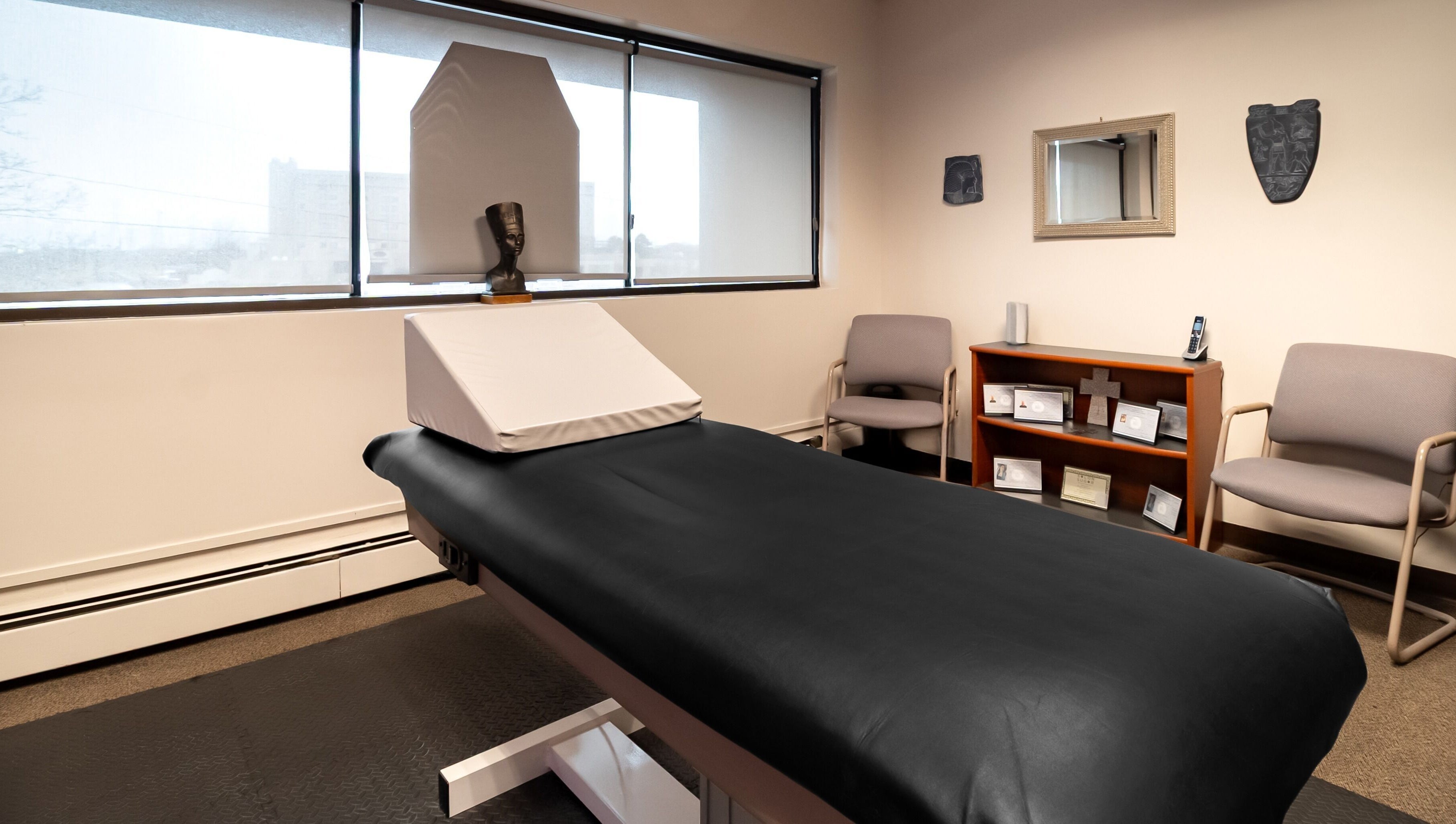 Relaxing treatment room at Sugar Body Eco-Spa, Buffalo, New York, US, featuring a massage table and serene decor.
