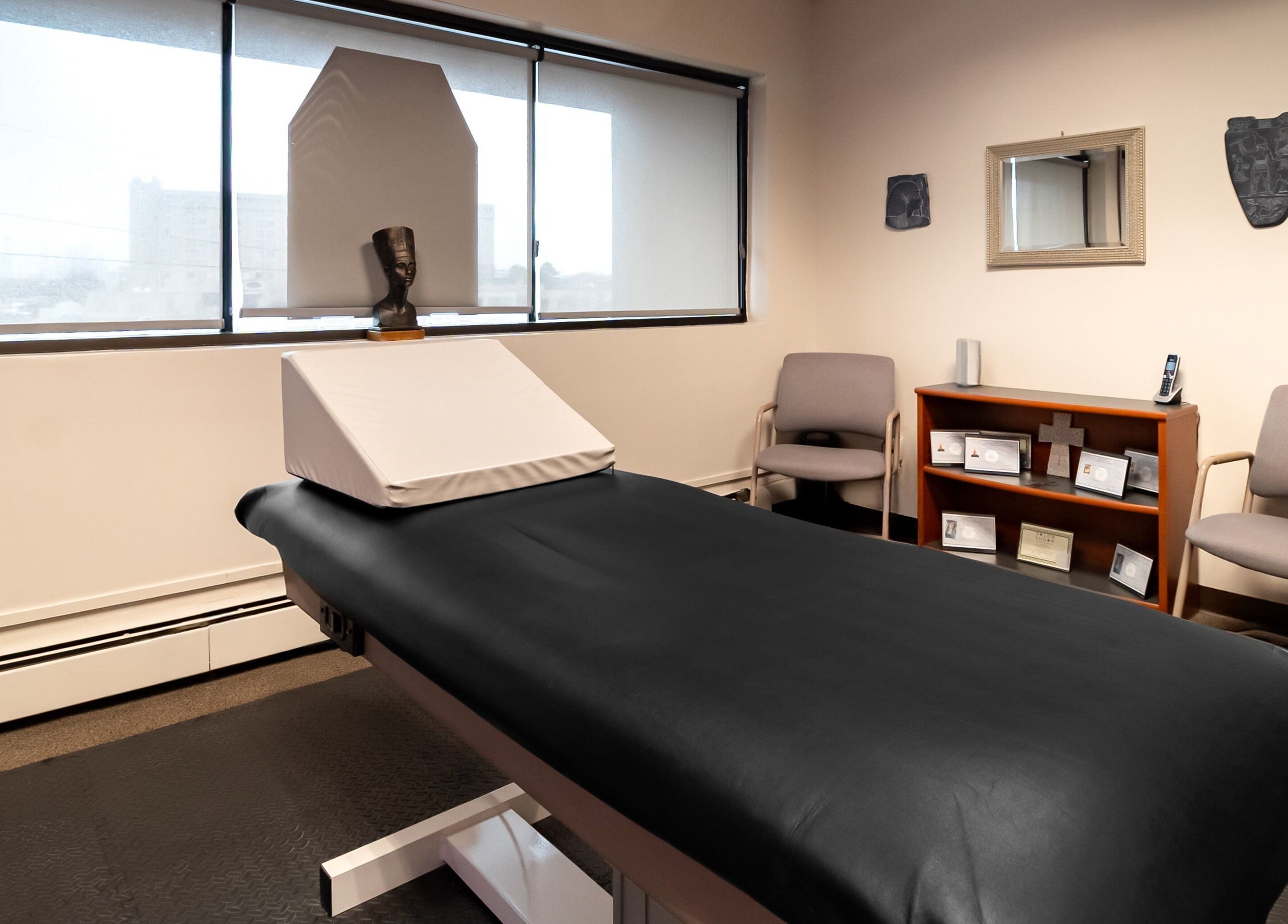 Relaxing treatment room at Sugar Body Eco-Spa, Buffalo, New York, US, featuring a massage table and serene decor.