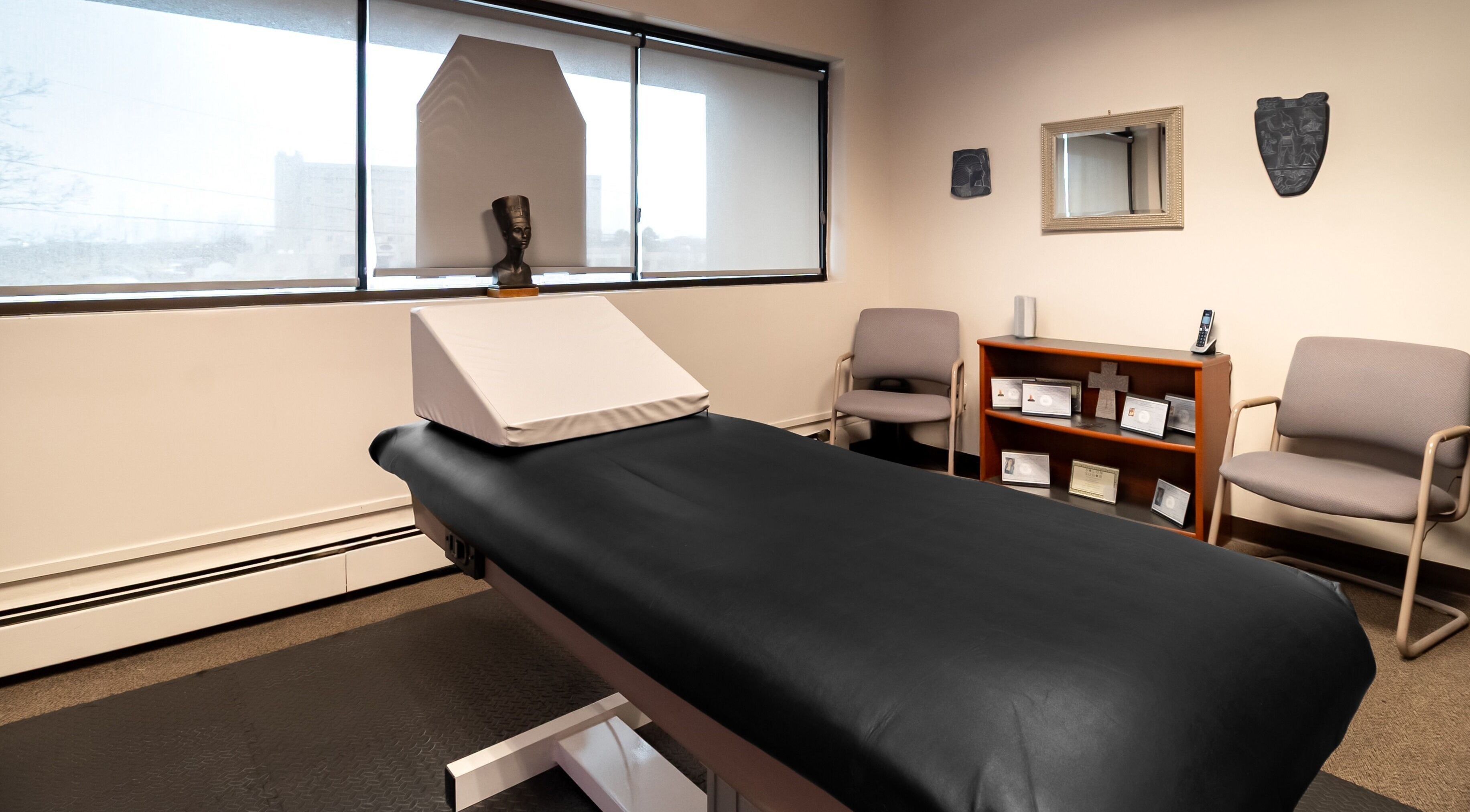Relaxing treatment room at Sugar Body Eco-Spa, Buffalo, New York, US, featuring a massage table and serene decor.