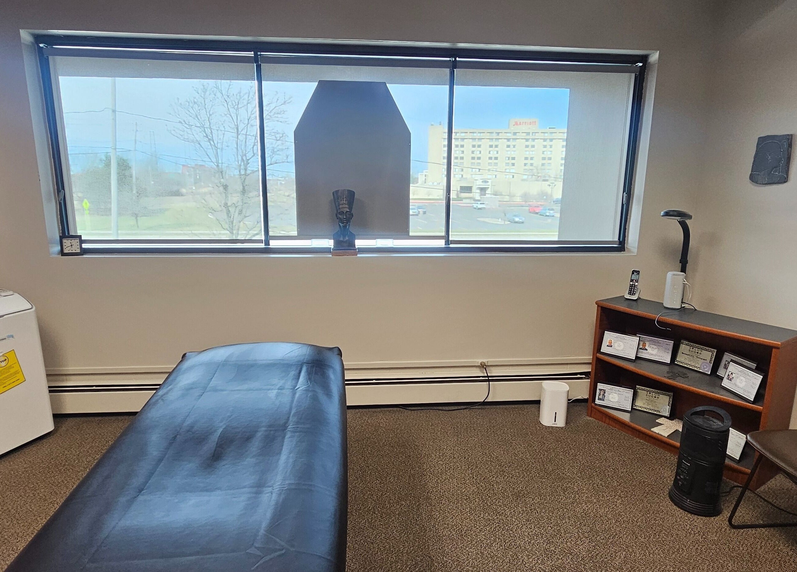 Cozy massage room at Sugar Body Eco-Spa in Buffalo, New York, with serene decor and relaxing ambiance.