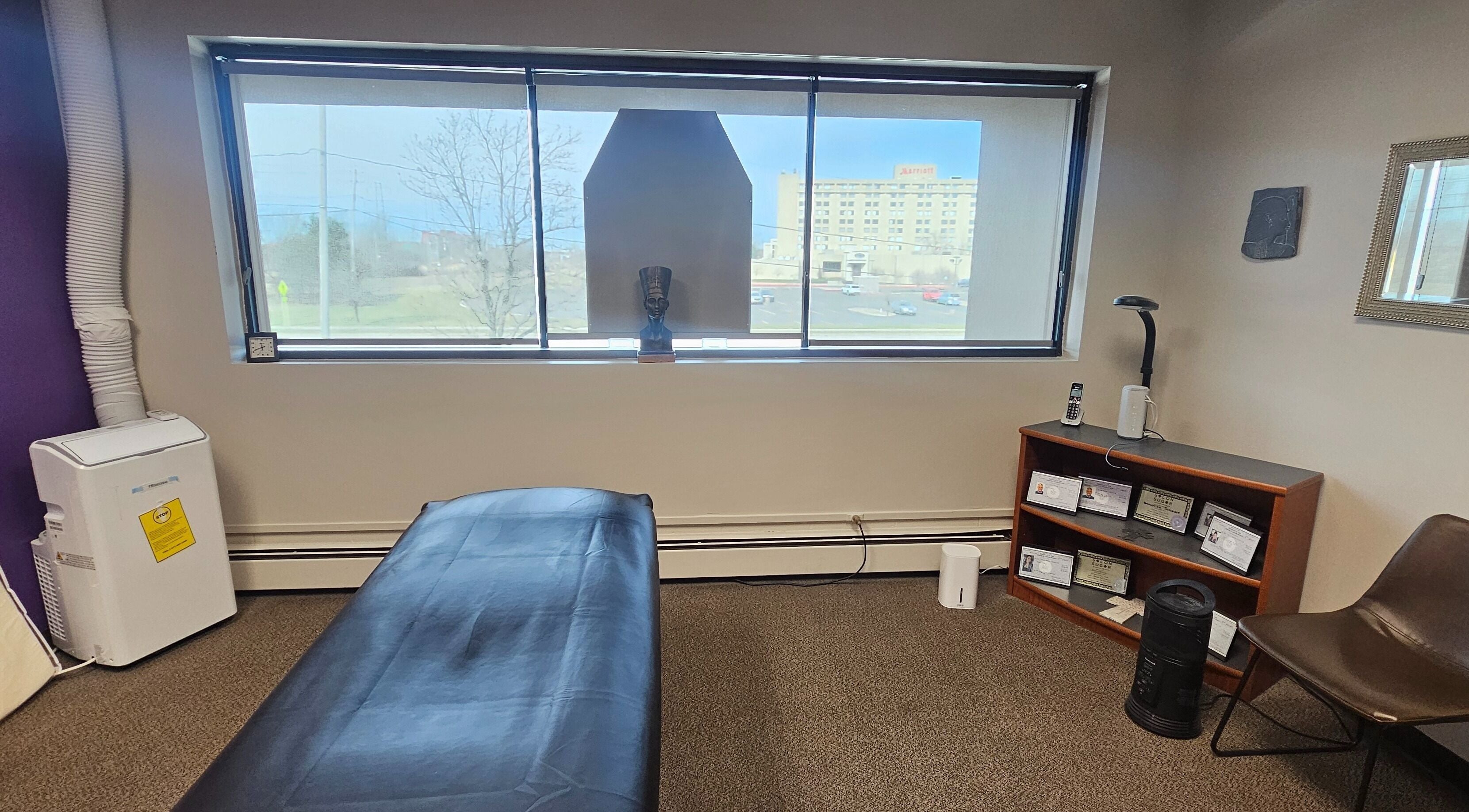 Cozy massage room at Sugar Body Eco-Spa in Buffalo, New York, with serene decor and relaxing ambiance.
