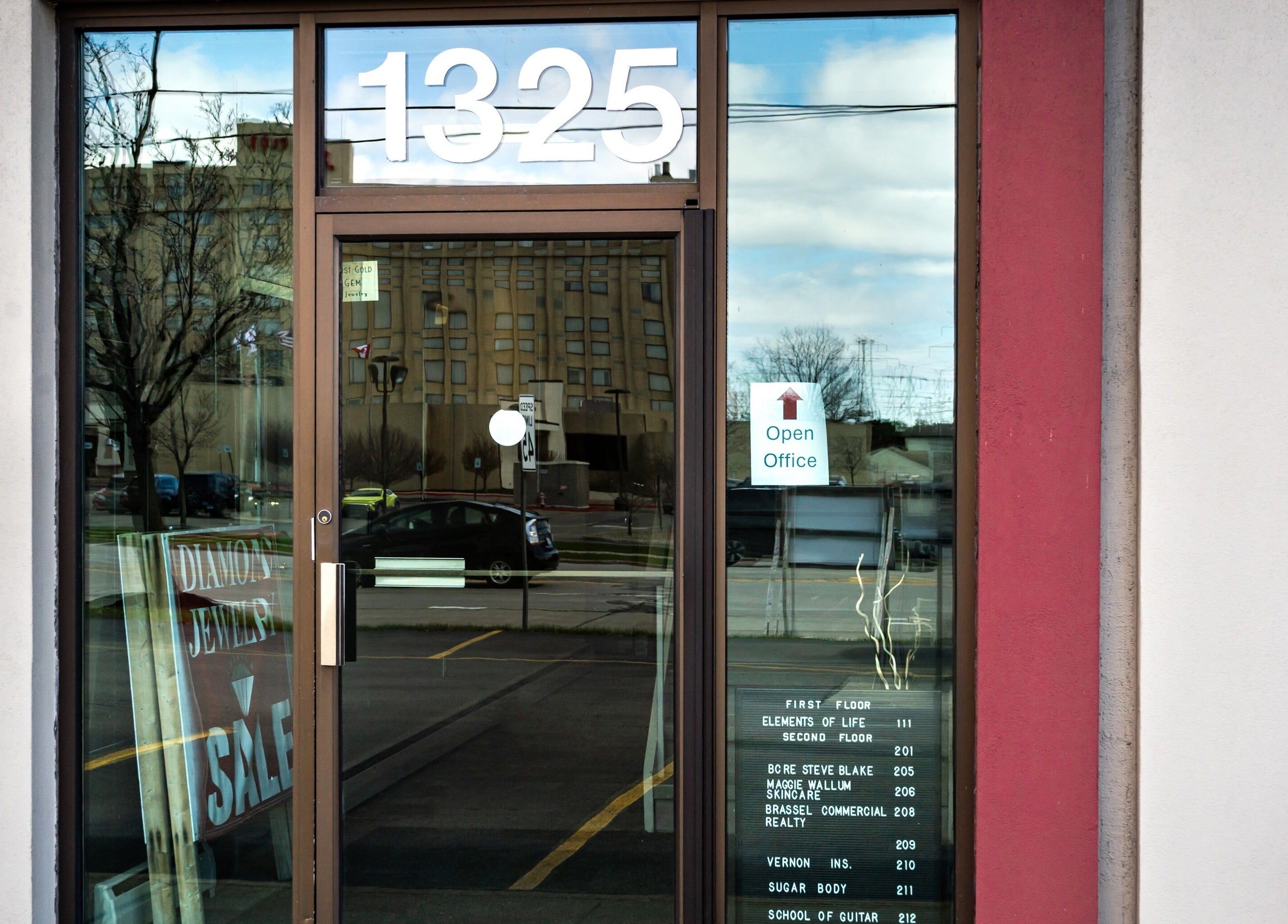Entrance to Sugar Body Eco-Spa in Buffalo, New York, US with reflective glass door.