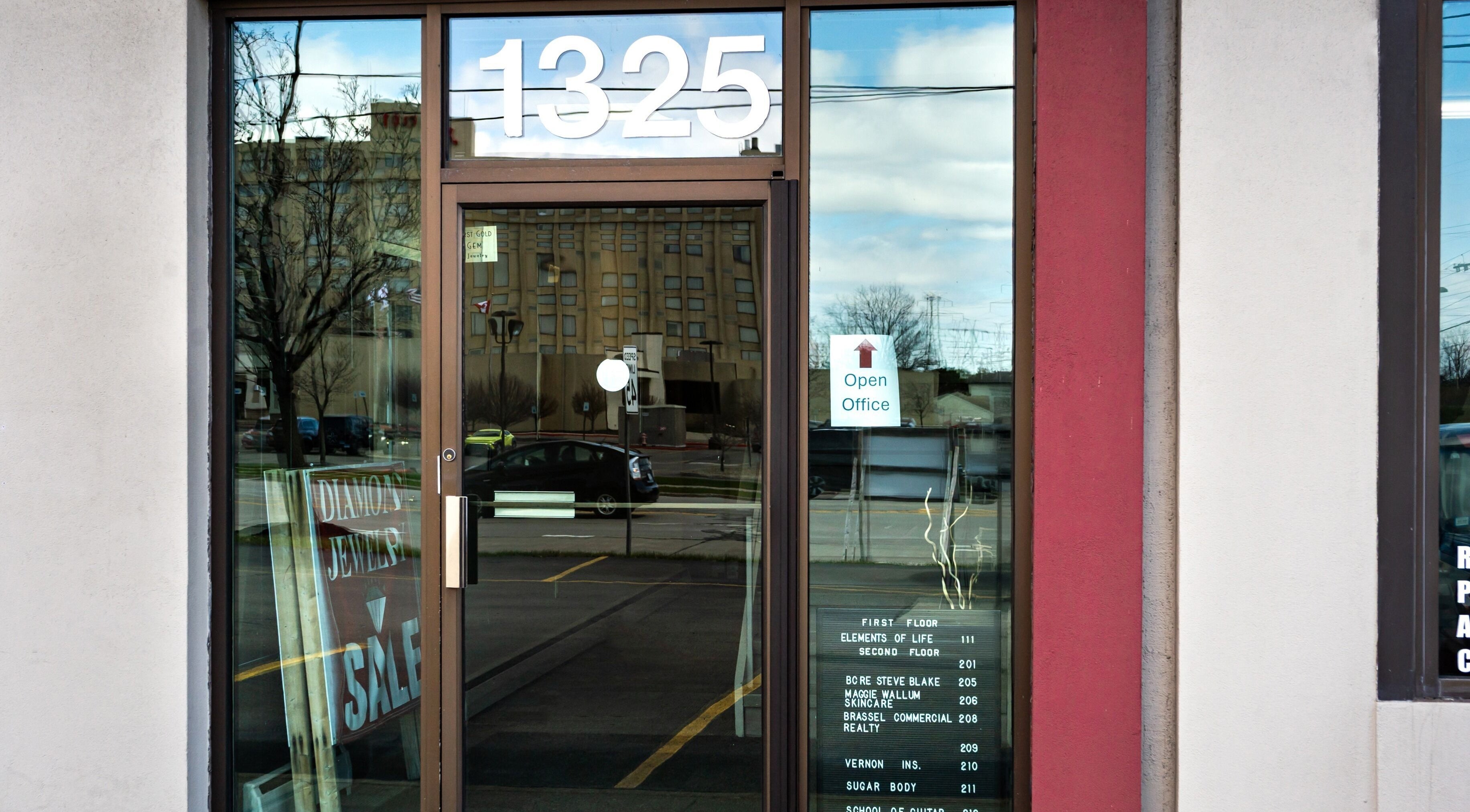 Entrance to Sugar Body Eco-Spa in Buffalo, New York, US with reflective glass door.