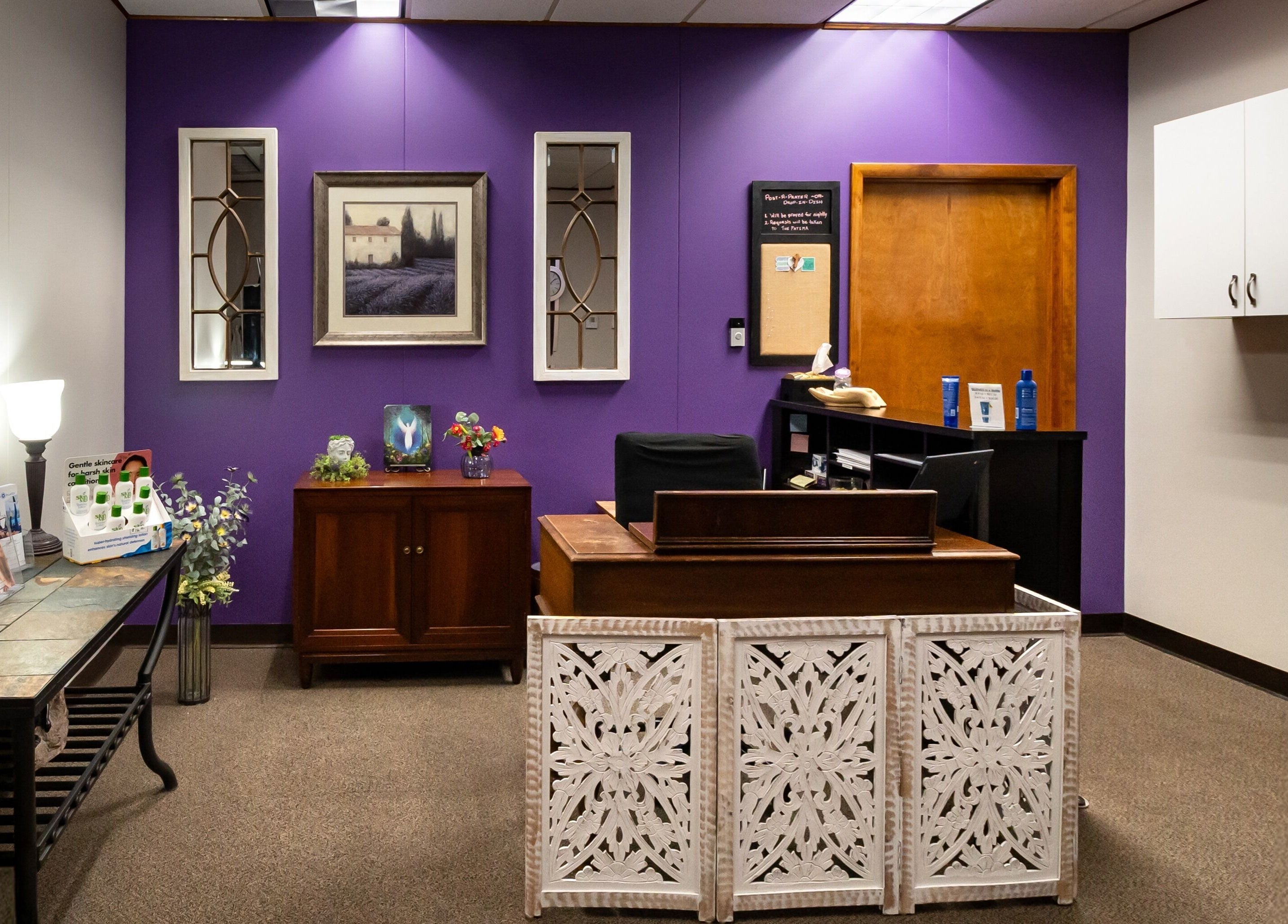 Reception area at Sugar Body Eco-Spa, Buffalo, New York, US with purple wall and elegant decor.