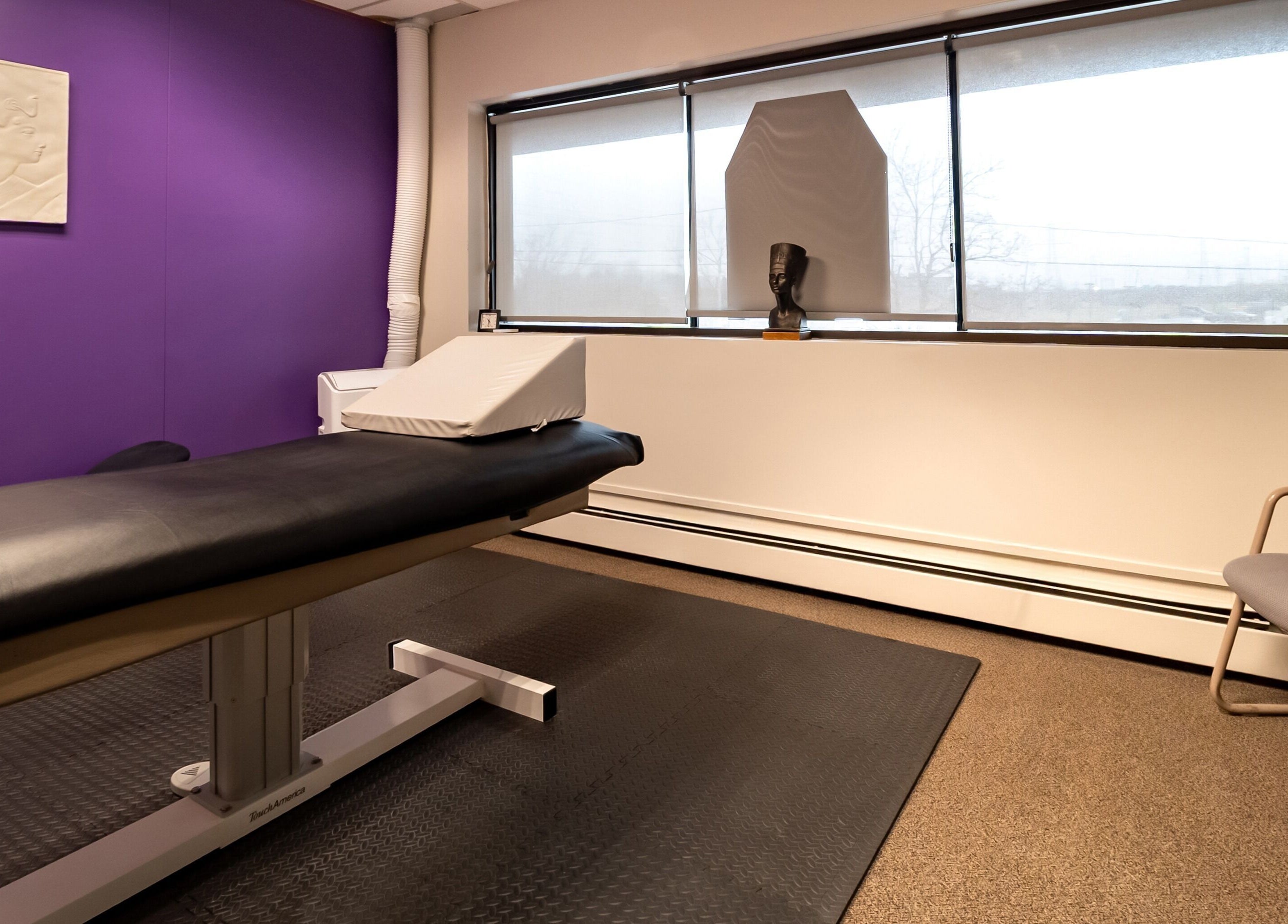 Calm therapy room at Sugar Body Eco-Spa, Buffalo, New York, US, featuring a comfortable massage table.