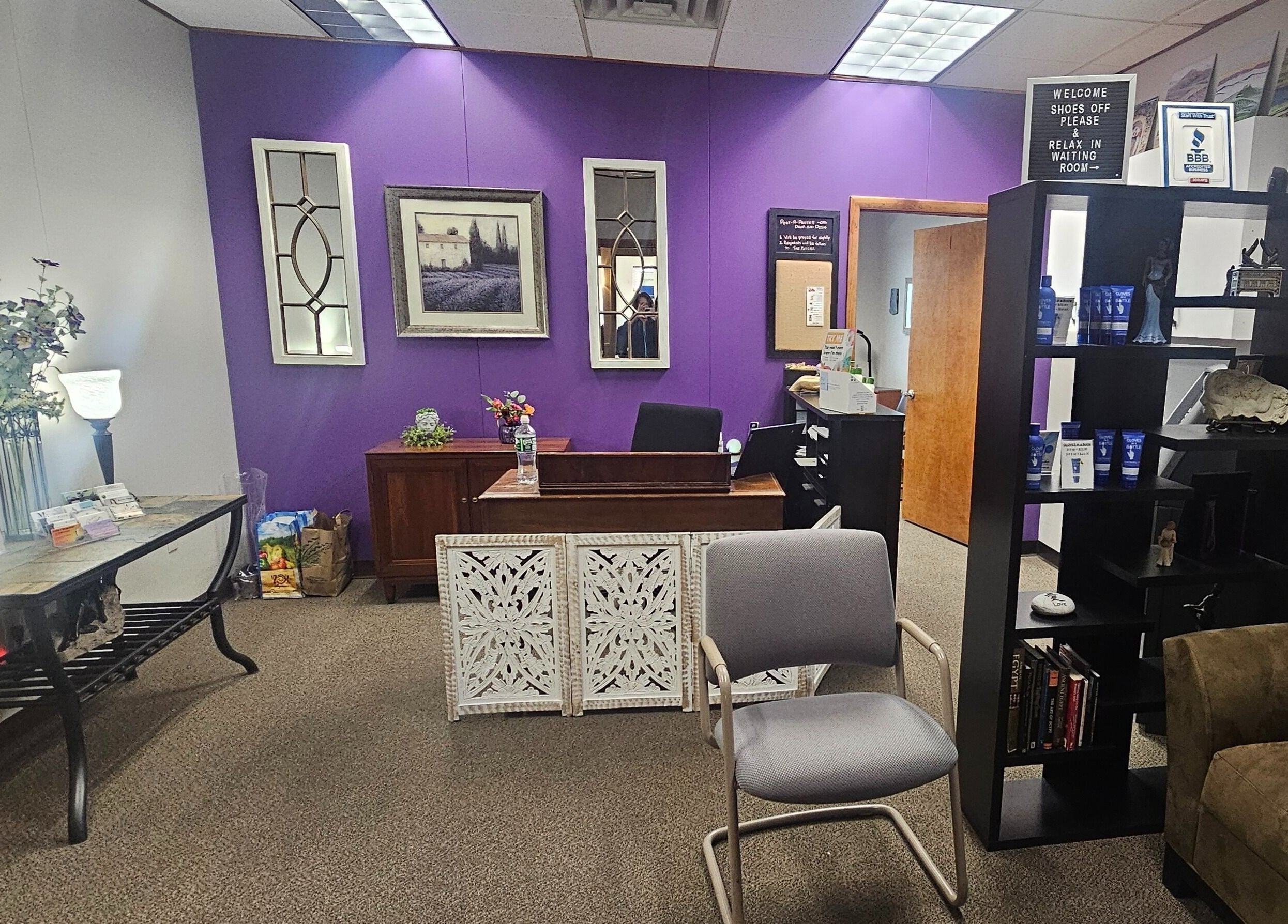 Reception area of Sugar Body Eco-Spa in Buffalo, New York, US with purple walls and decorative elements.