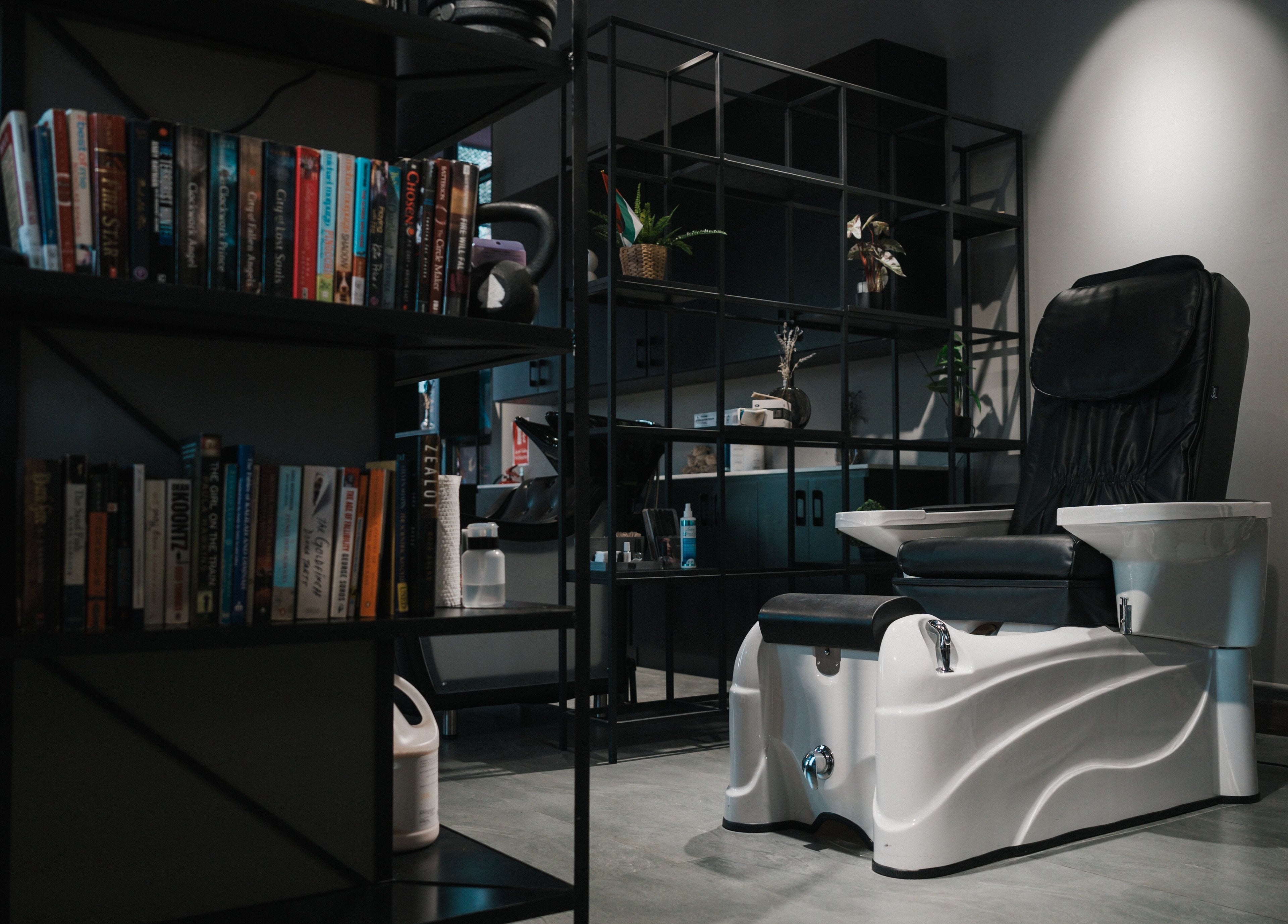 Stylish pedicure station at Ace of Fades Mens Salon, أبو ظبي, أبو ظبي, AE, with modern decor and bookshelves.