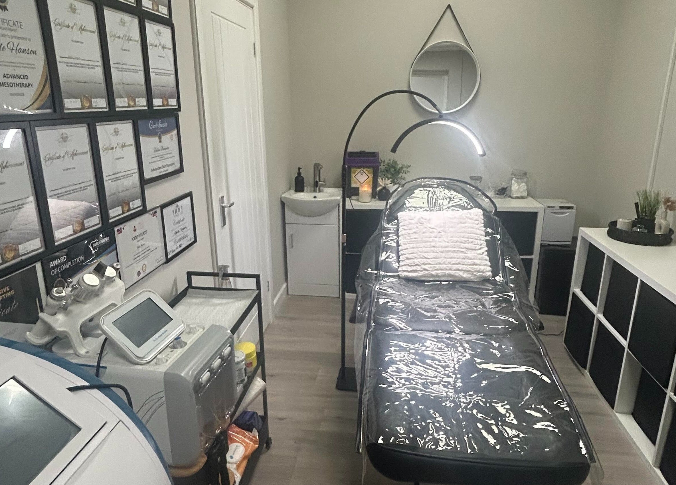 Elegant treatment room at Adeles Aesthetics and Beauty, Seaham, England, GB with certifications displayed.