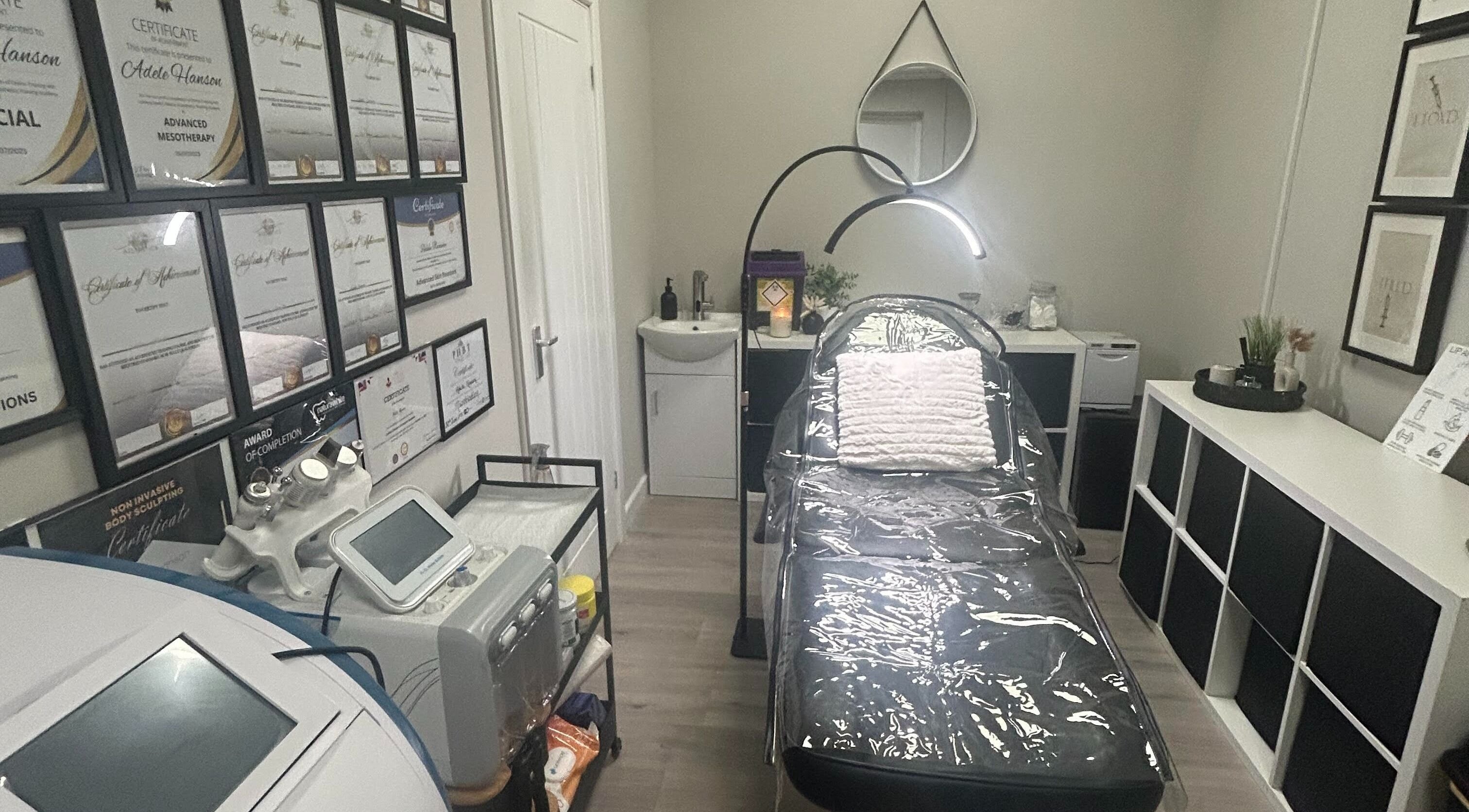 Elegant treatment room at Adeles Aesthetics and Beauty, Seaham, England, GB with certifications displayed.