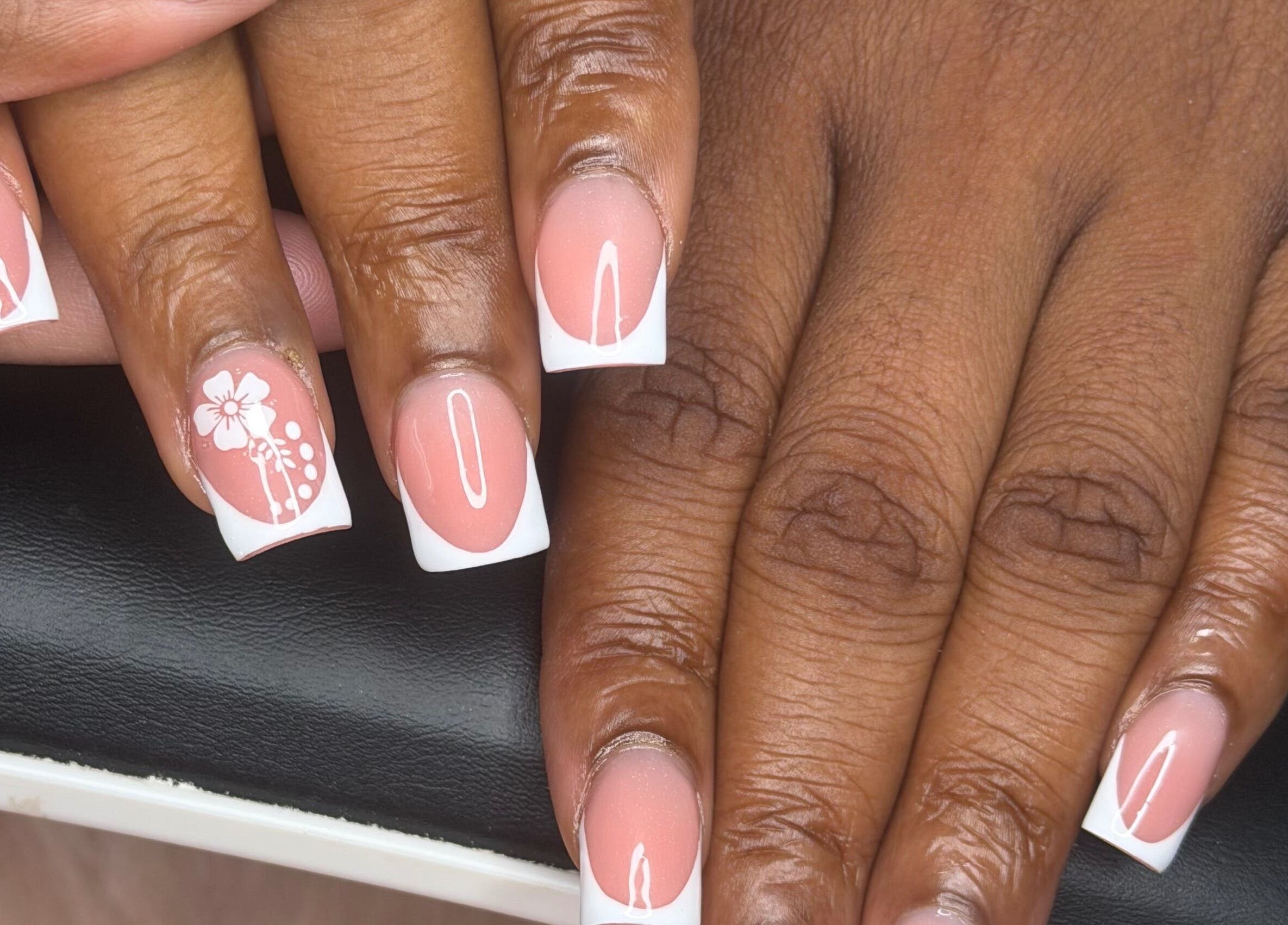 Elegant French manicure with floral design at ChicTips by Rae, Charlotte, North Carolina, US.