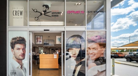 Front entrance of Riverlink - Gaye's Hair Fashions in North Ipswich, Queensland, AU, showcasing vibrant posters.