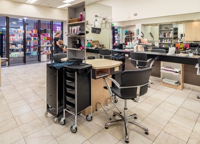 Interior of Booval - Gaye's Hair Fashions, a stylish salon in Booval, Queensland, AU with chic black chairs.
