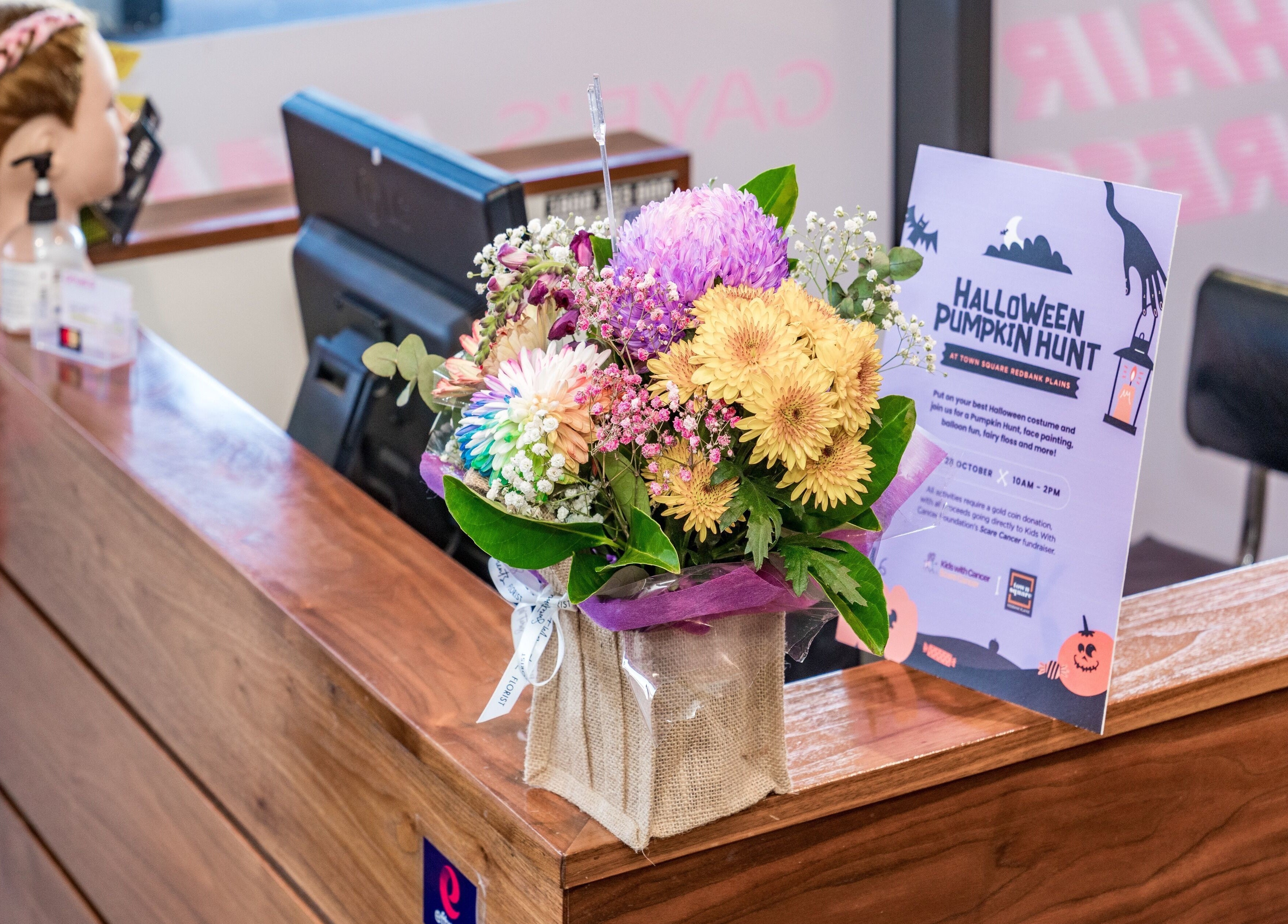 Reception desk with flowers at Redbank Plains - Gaye's Hair Fashions, Redbank Plains, Queensland, AU.