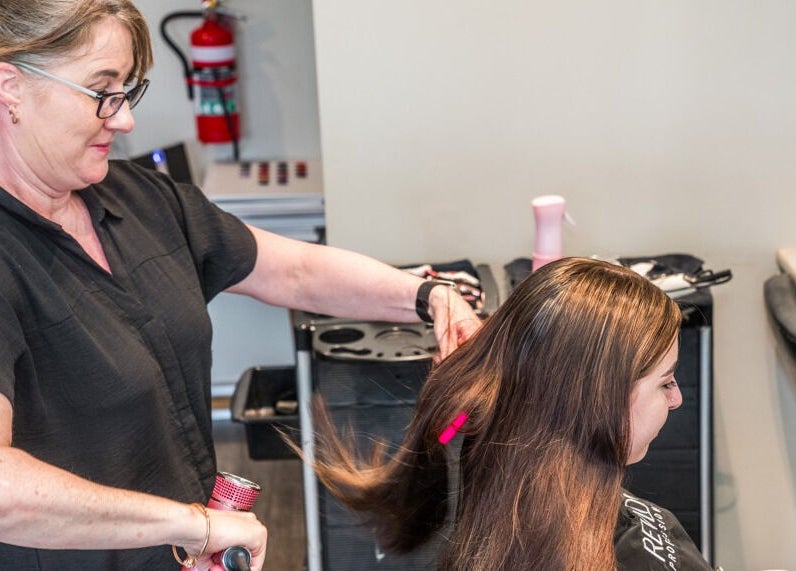 Hairdresser styling long hair at Redbank Plains - Gaye's Hair Fashions, Redbank Plains, Queensland, AU.