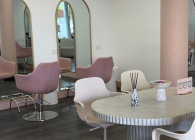 Inside Olivia's Secret Hair and Beauty, Buddina, Queensland, AU showing stylish salon chairs and mirrors.