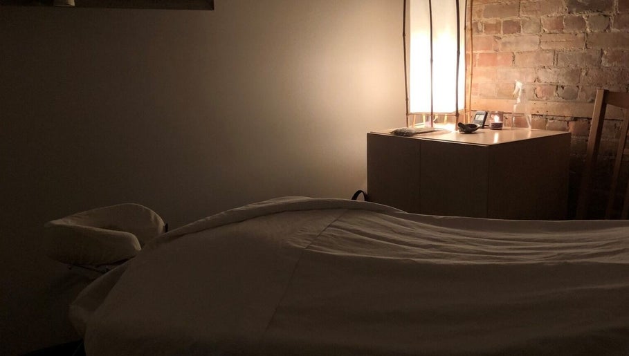 Cozy massage room at Mindful Massage, Pembroke, Ontario, CA with soft lighting and a peaceful atmosphere.