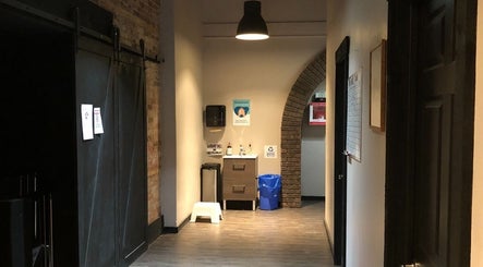 Welcoming hallway at Mindful Massage, Pembroke, Ontario, CA featuring soft lighting and modern decor.
