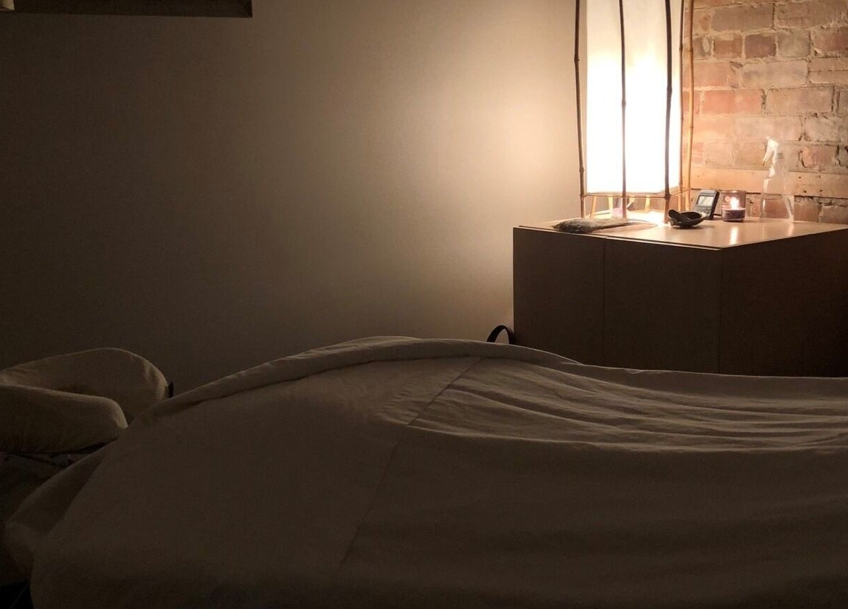 Relaxing massage room at Mindful Massage in Pembroke, Ontario, CA, featuring soft lighting and calming ambiance.