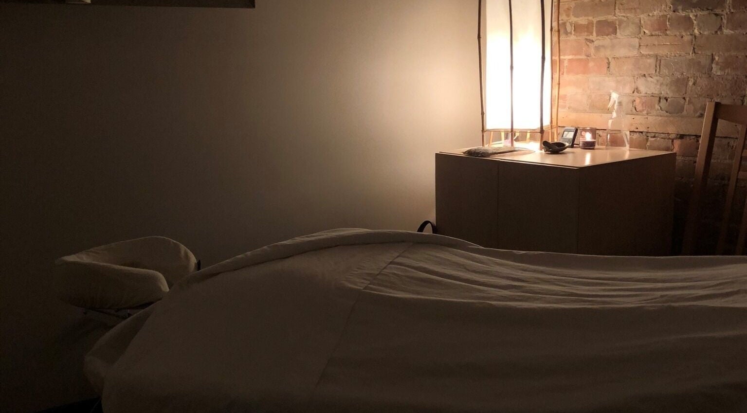 Relaxing massage room at Mindful Massage in Pembroke, Ontario, CA, featuring soft lighting and calming ambiance.