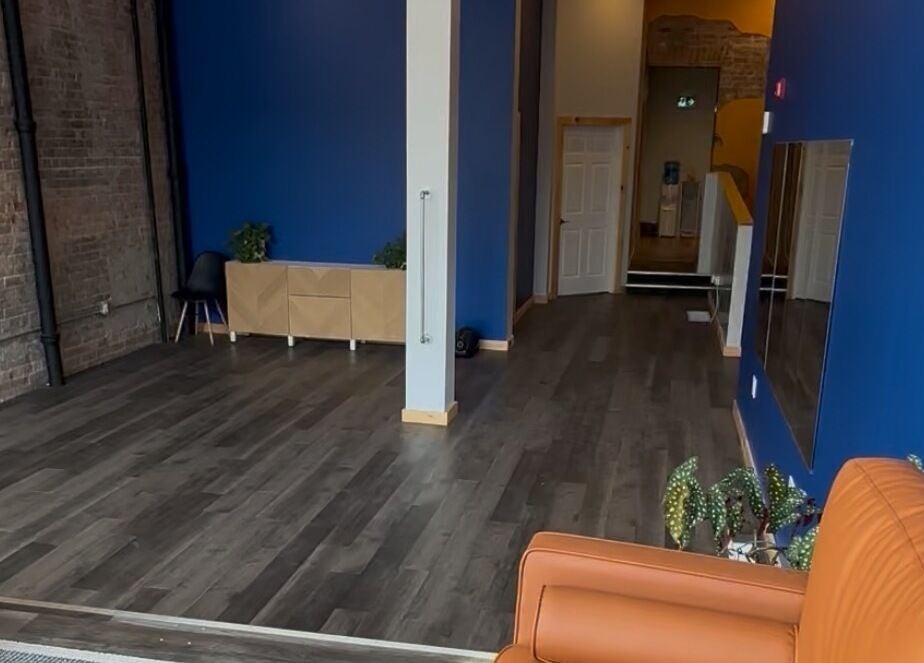 Spacious interior of Nourish U Wellness Centre in Pembroke, Ontario, CA with blue walls and stylish decor.