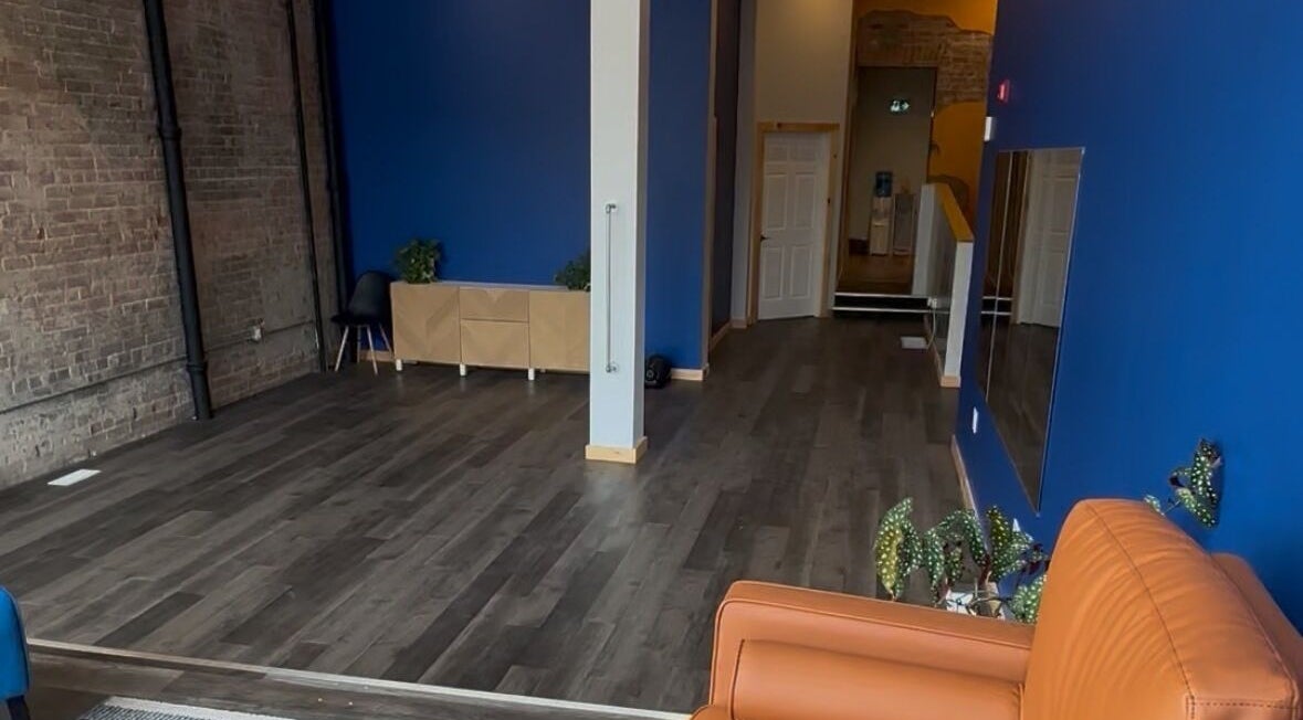 Spacious interior of Nourish U Wellness Centre in Pembroke, Ontario, CA with blue walls and stylish decor.