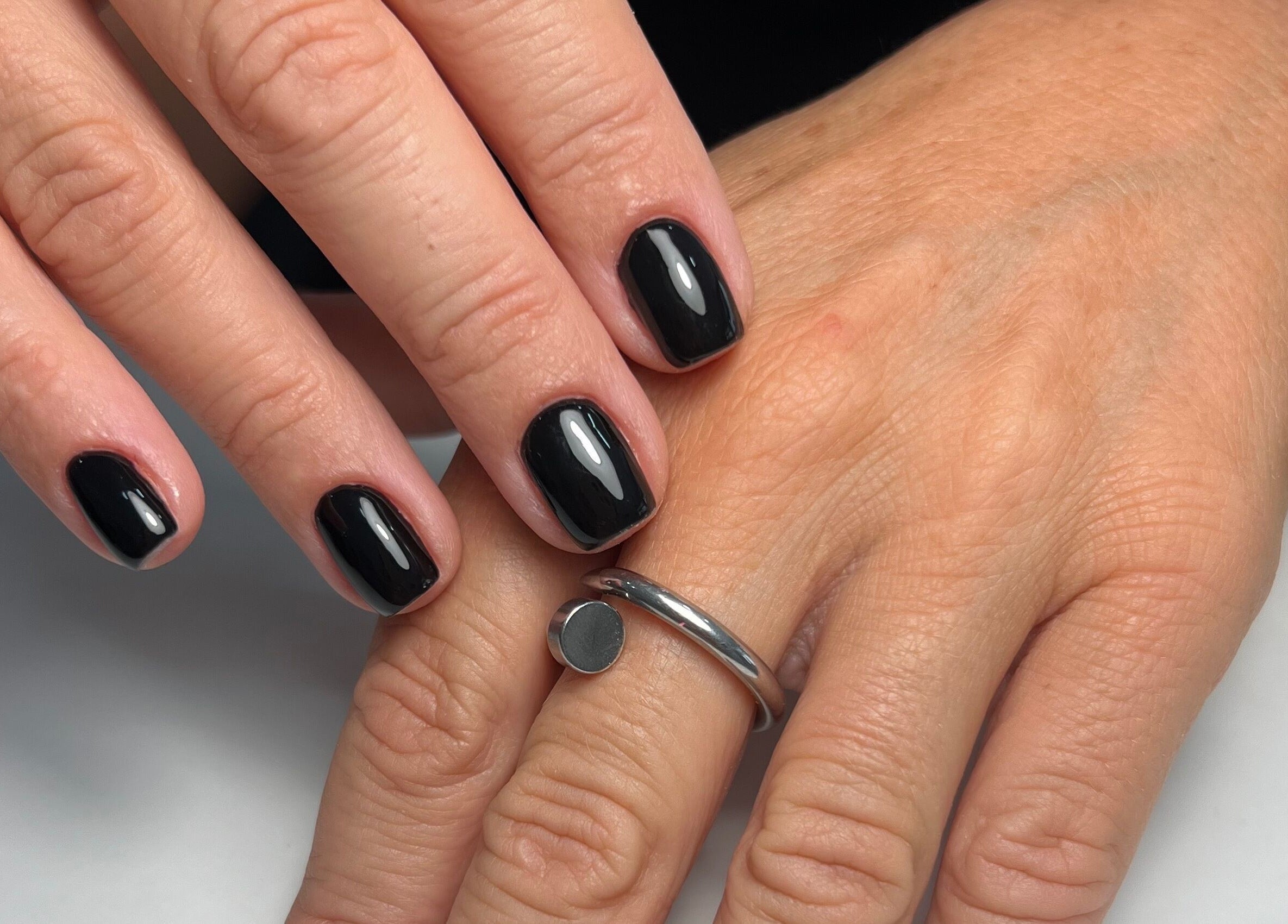 Manicure elegante em La Bellezza Studio, Algés, Lisboa, PT, com unhas pretas bem cuidadas.