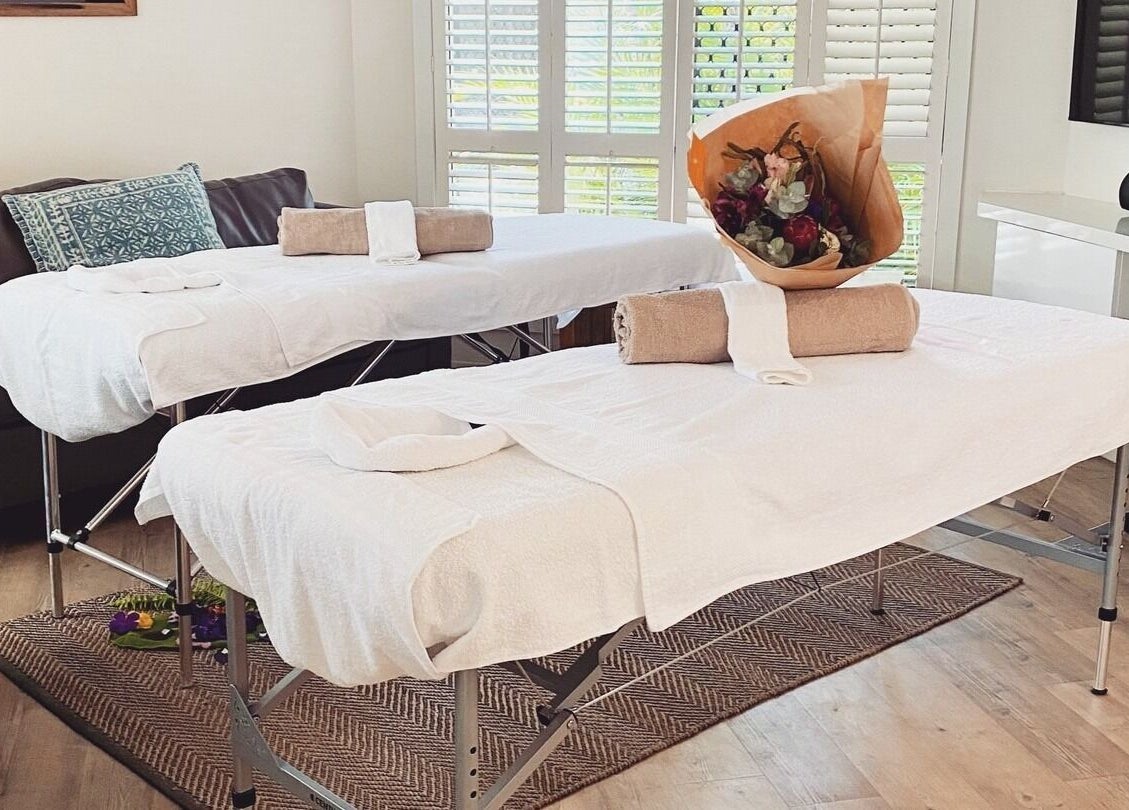 Relaxing massage tables at Reflect Mobile Spa Agnes Water, Agnes Water, Queensland, AU with flowers and towels.